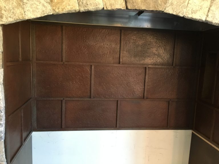 This back splash was made from textured sheet metal and flat bar.  Finished with a hand buffed patina.