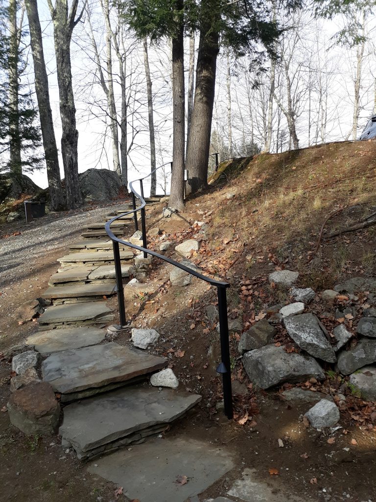 This handrail had to be bent to follow the irregular curve of these stone steps.  But that's not all.  It also had to have electrical installed to support the lights at the base of each post.