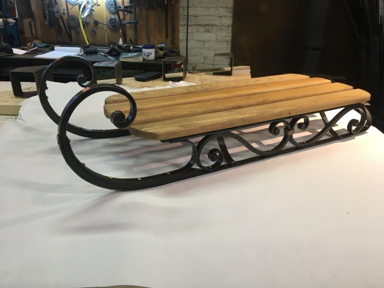 sled made with forged flat bar, brass rivets, and bronze collars.