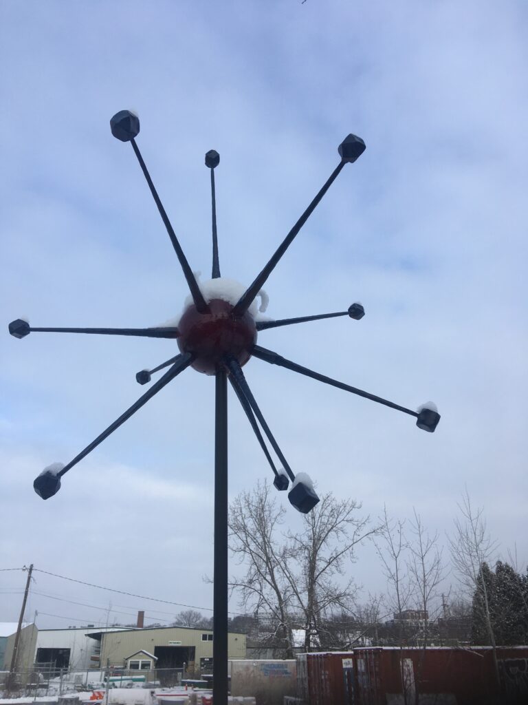 Starburst finial with a red center and ball-tipped spokes