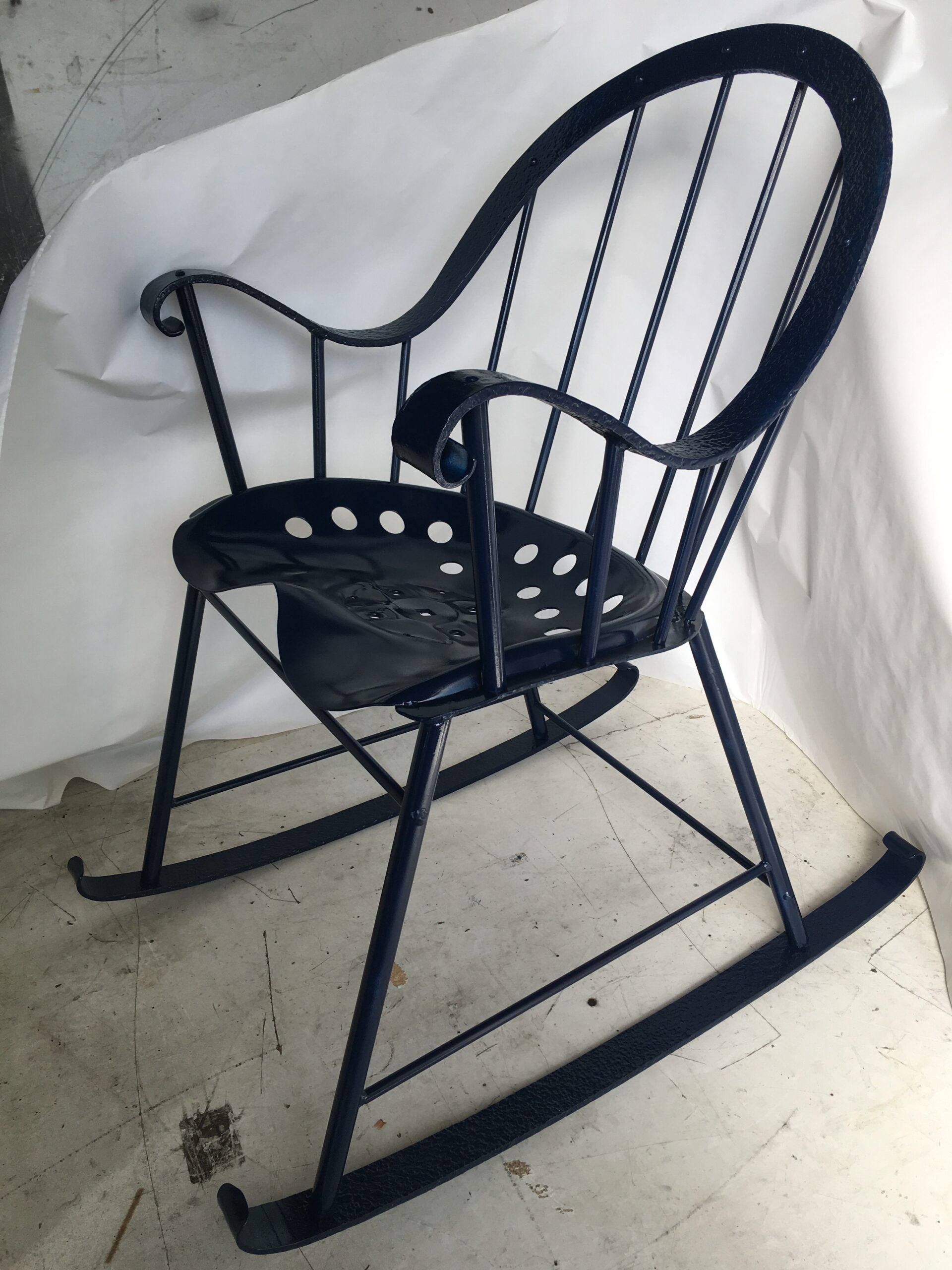 Forged metal Windsor rocking chair with a tractor seat