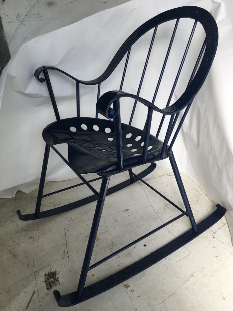 Forged metal Windsor rocking chair with a tractor seat