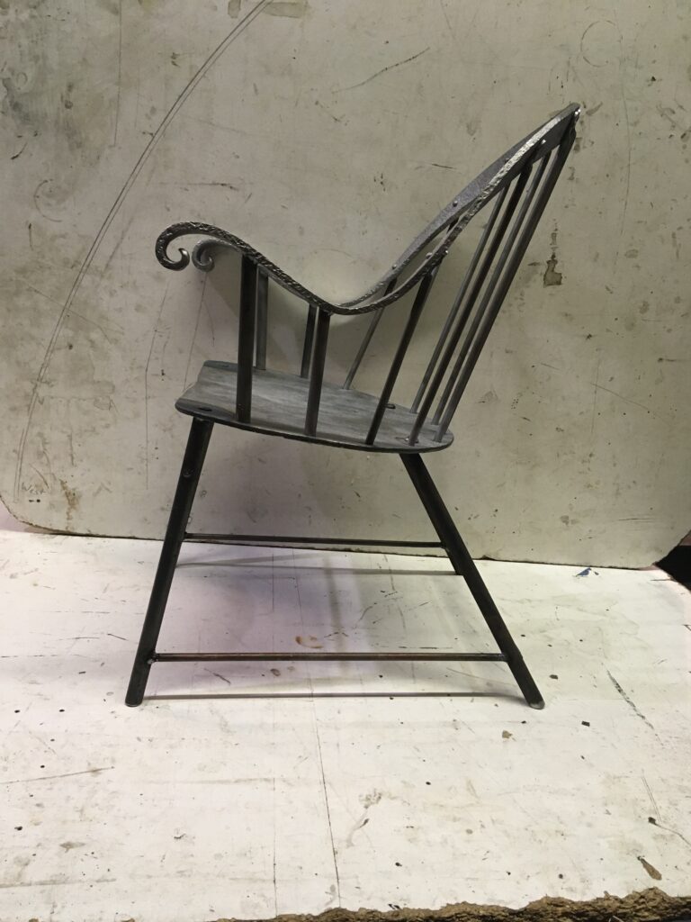 Forged metal Windsor chair seen from the side