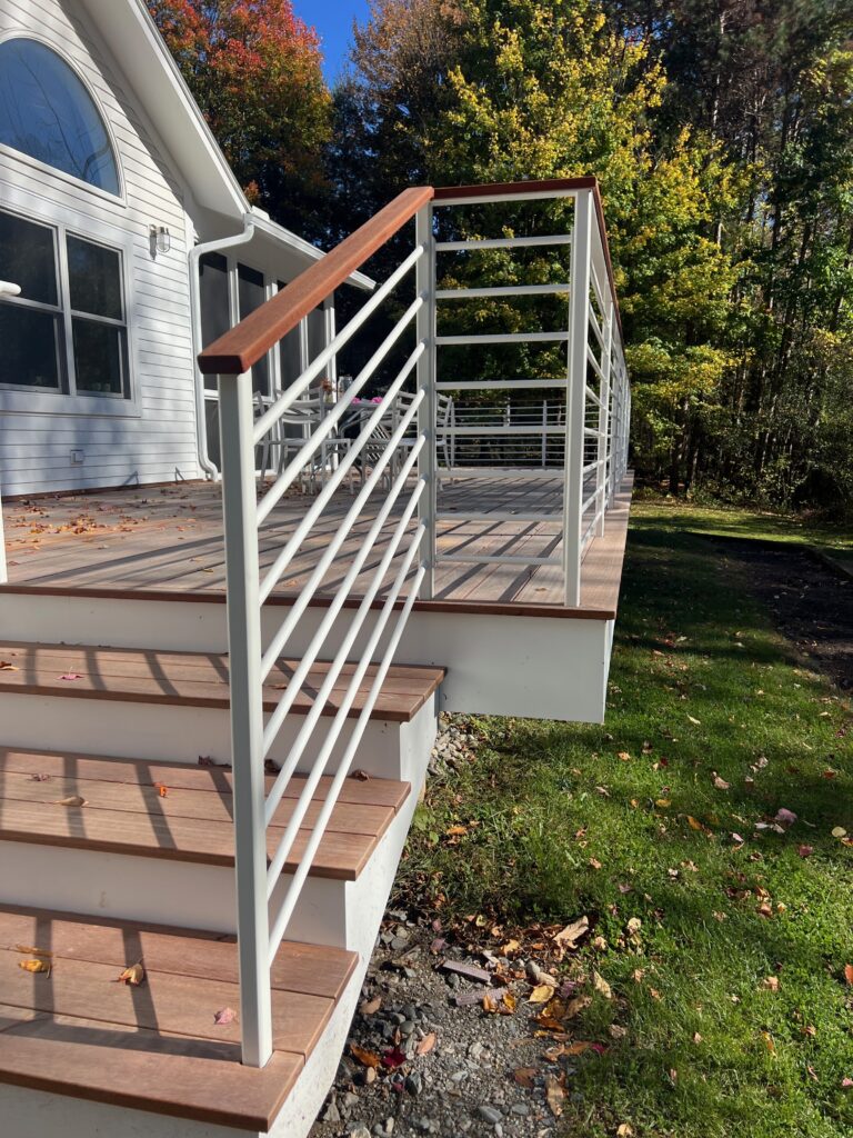 White powder-coated horizontal-rod deck railing beside wood steps
